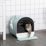 Pet litter box with a cat peeking out, set against a tiled wall.