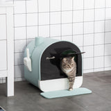 Pet litter box with a cat peeking out, set against a tiled wall.